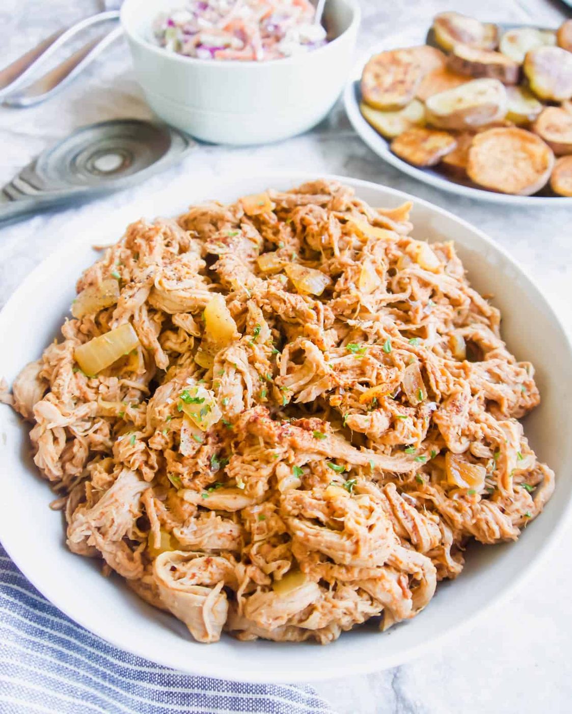 Slow Cooker Pulled Pork Tenderloin with Tomato and Maple in a large bowl.