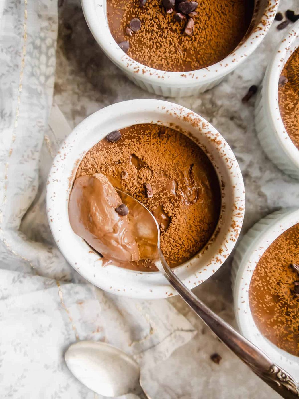 A spono in a ramekin of vegan chocolate pudding.