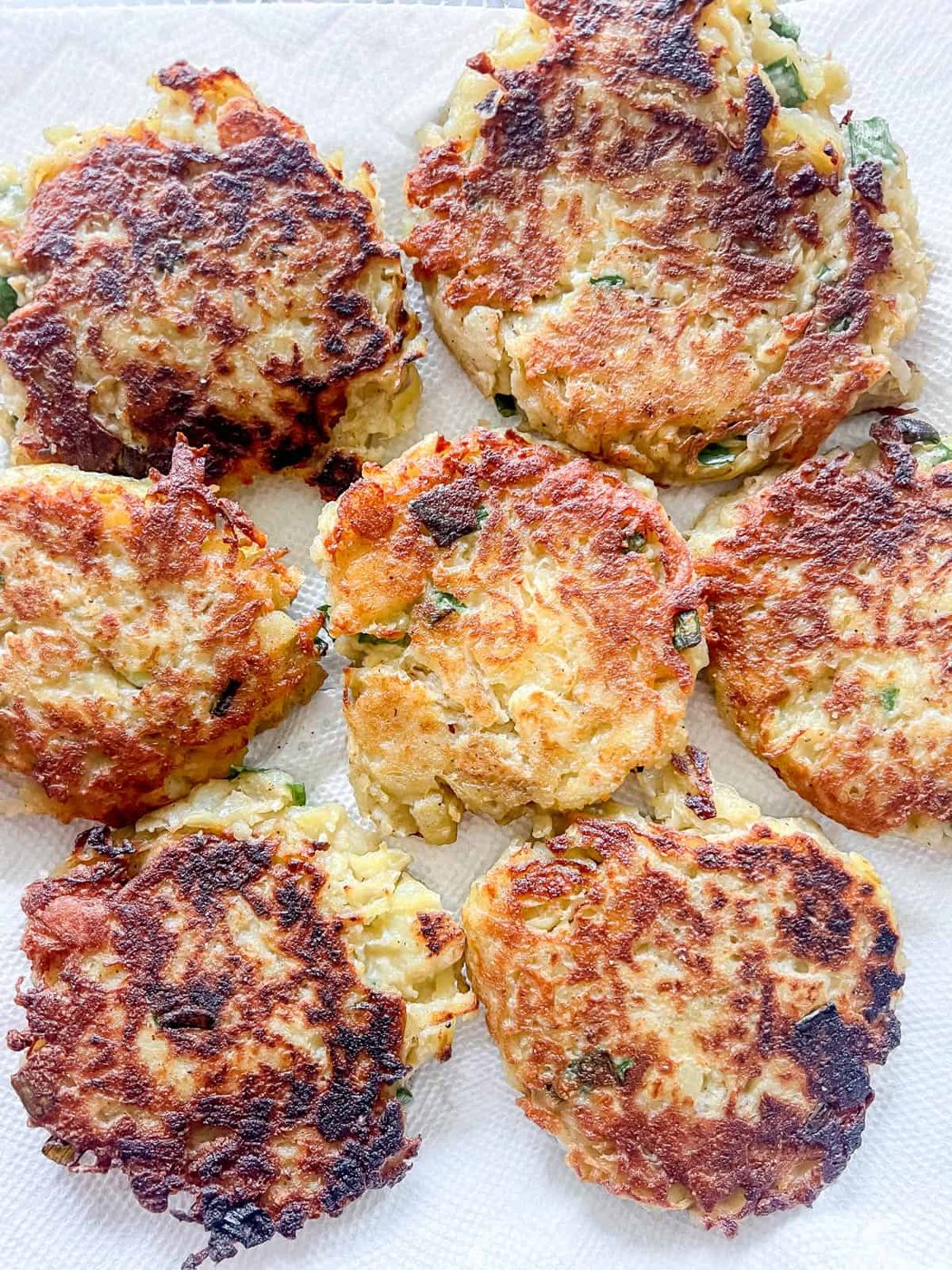 Cooked lighter potato pancakes on a paper towel.