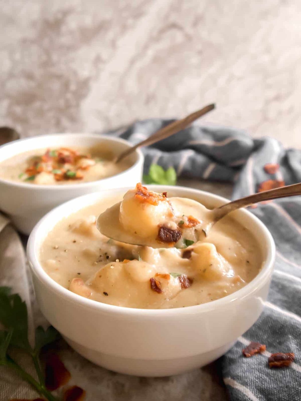 A spoonful of Whole30 potato soup being lifted out of a bowl.