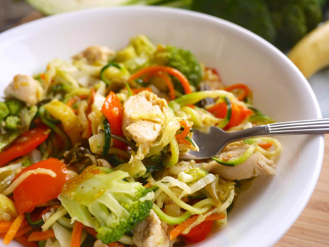 Paleo diet stir fry in a bowl with a fork in it.