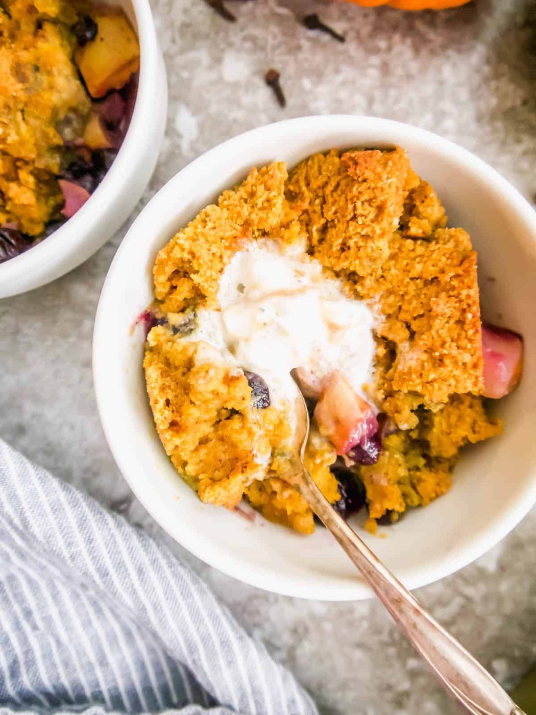 Gluten-free blueberry and pear cobbler with ice-cream on top.