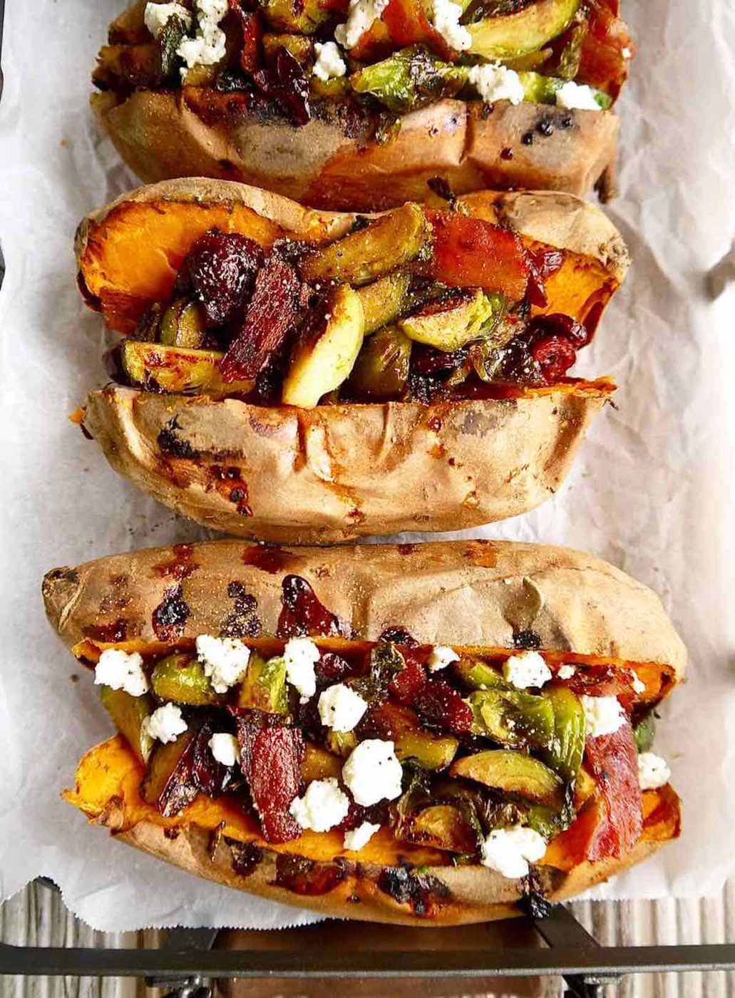 Baked sweet potatoes stuffed with maple bacon brussels sprouts, cranberries and goat cheese.