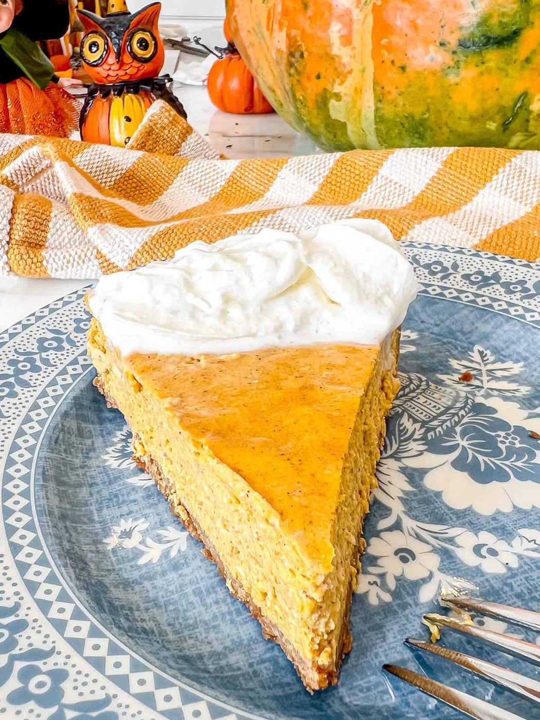Pumpkin Cheesecake with Gingersnap Graham Cracker Crust with whipped cream on top.