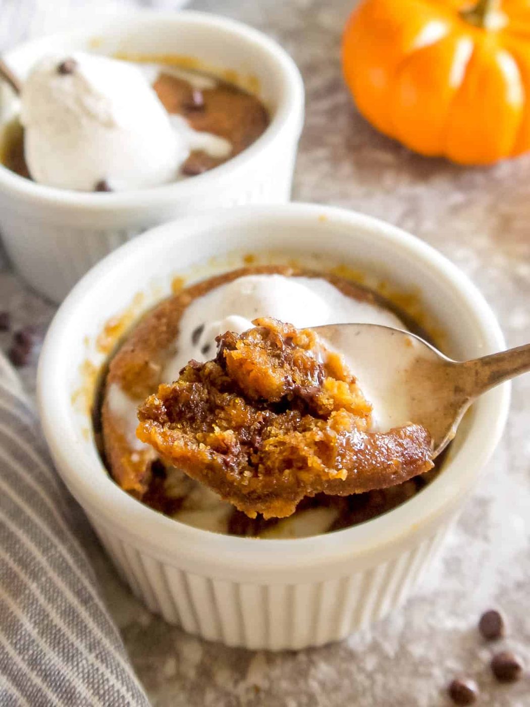 A bite of a pumpkin chocolate chip mug cake on a spoon.