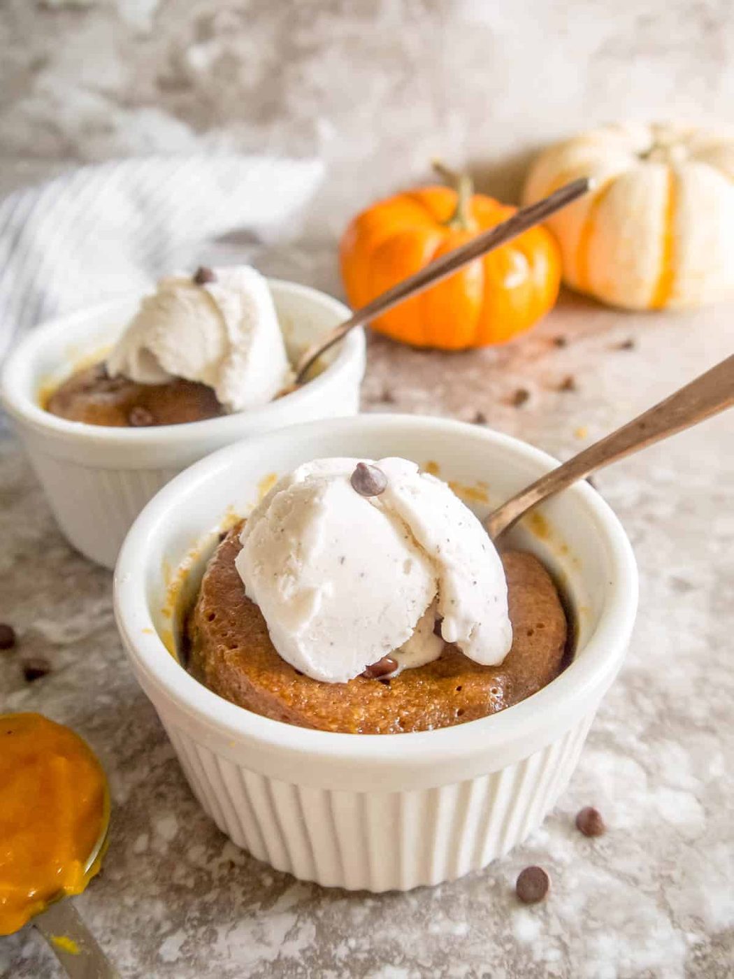 Pumpkin mug cookie with ice-cream on top.