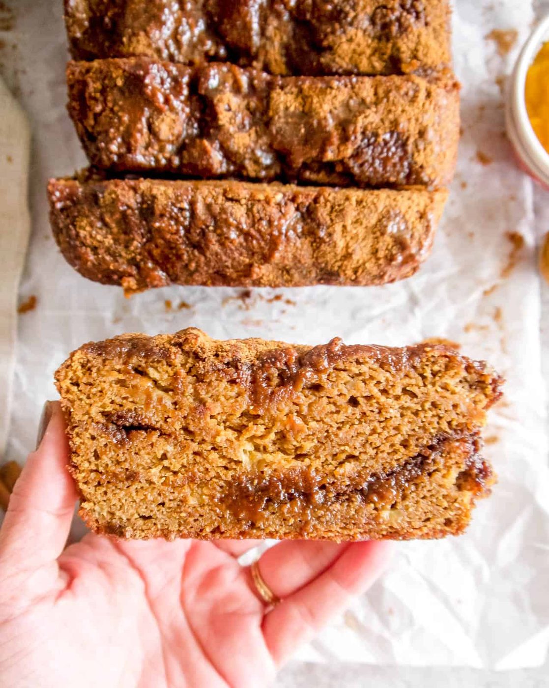 Paleo pumpkin banana bread in someone's hands.
