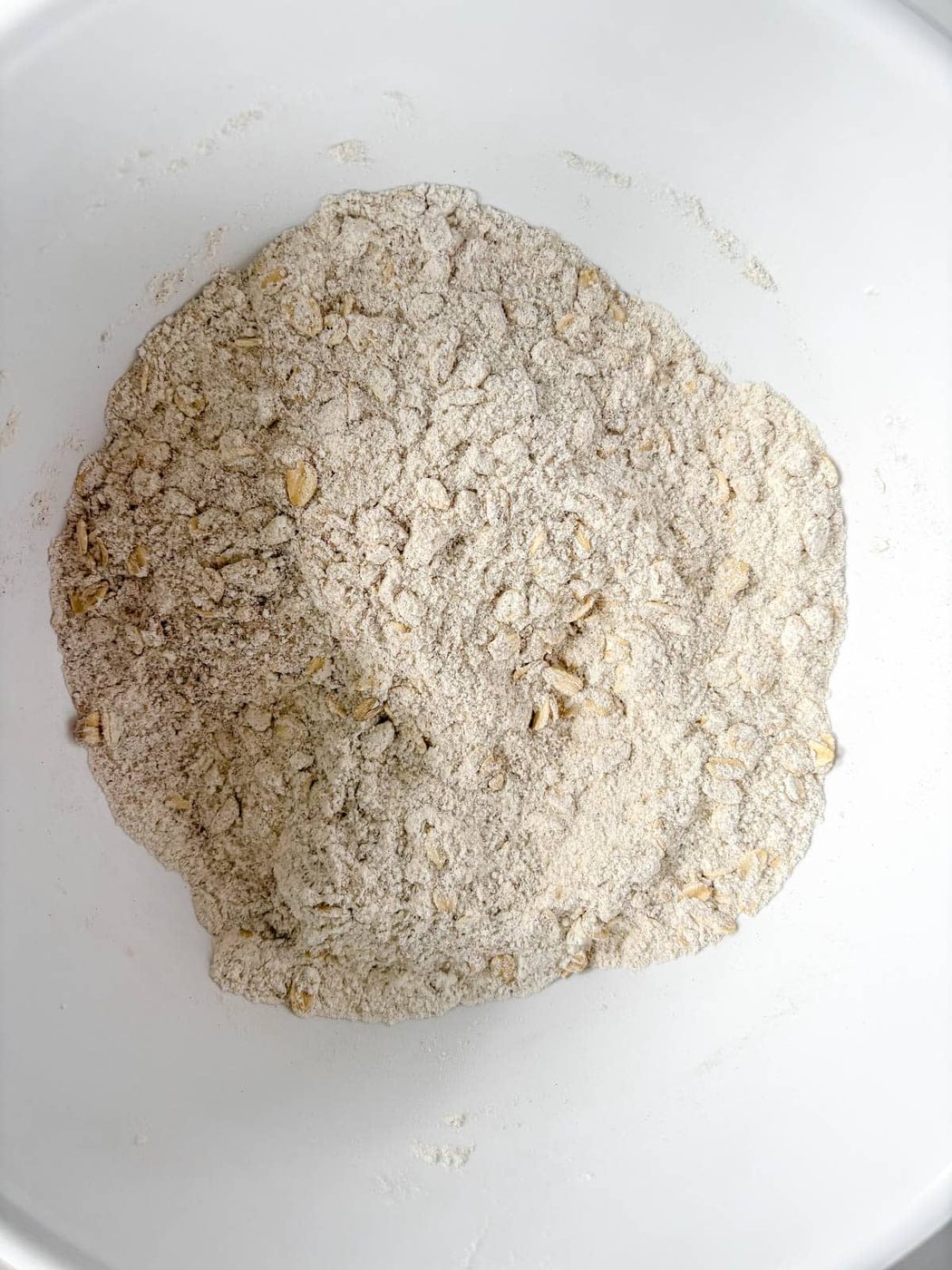 Dry oat ingredients in a bowl used to make pumpkin oat muffins.