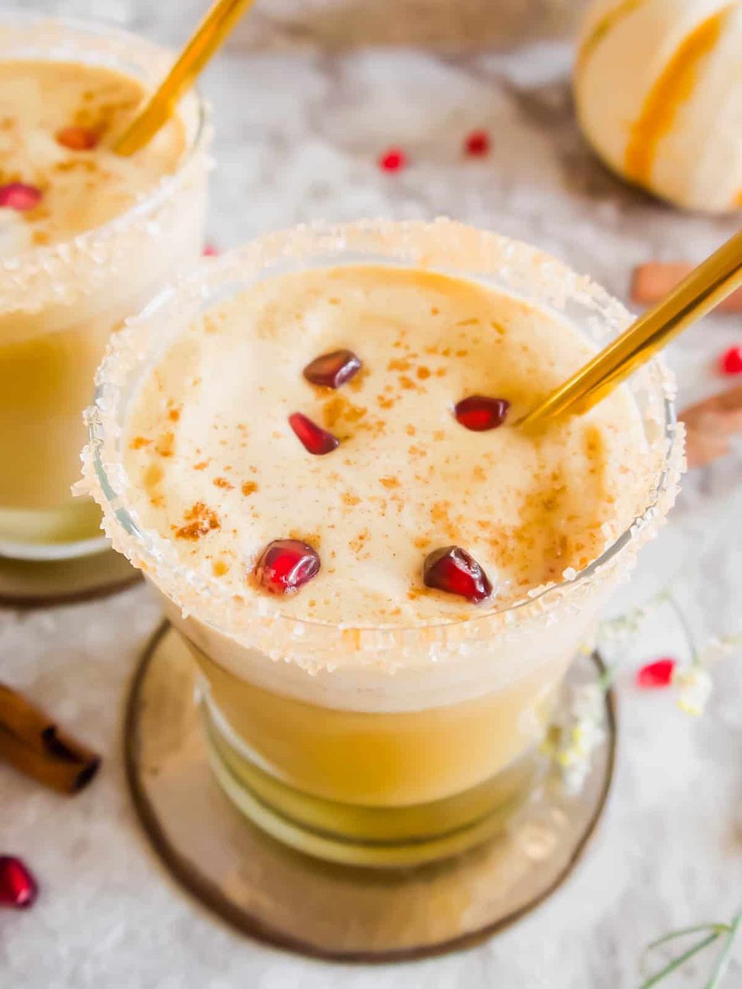 Fall white Russian in a cup with pomegranate seeds inside.