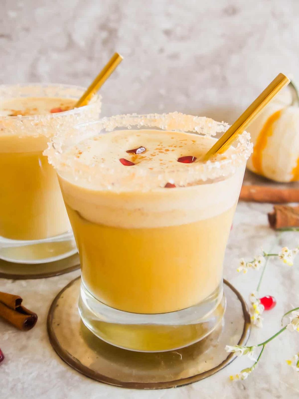 Pumpkin white Russian in cup rimmed with sugar.