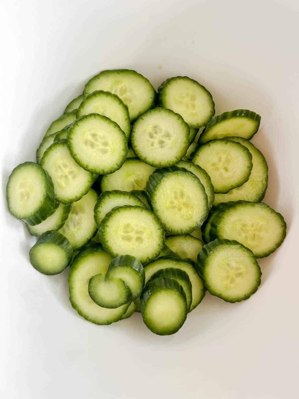 Sliced cucumbers in a bowl.
