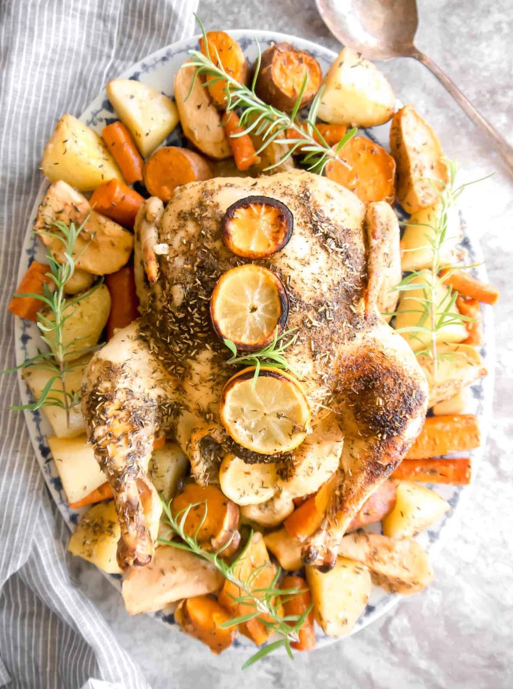 Freshly roasted chicken with apples on a plate.