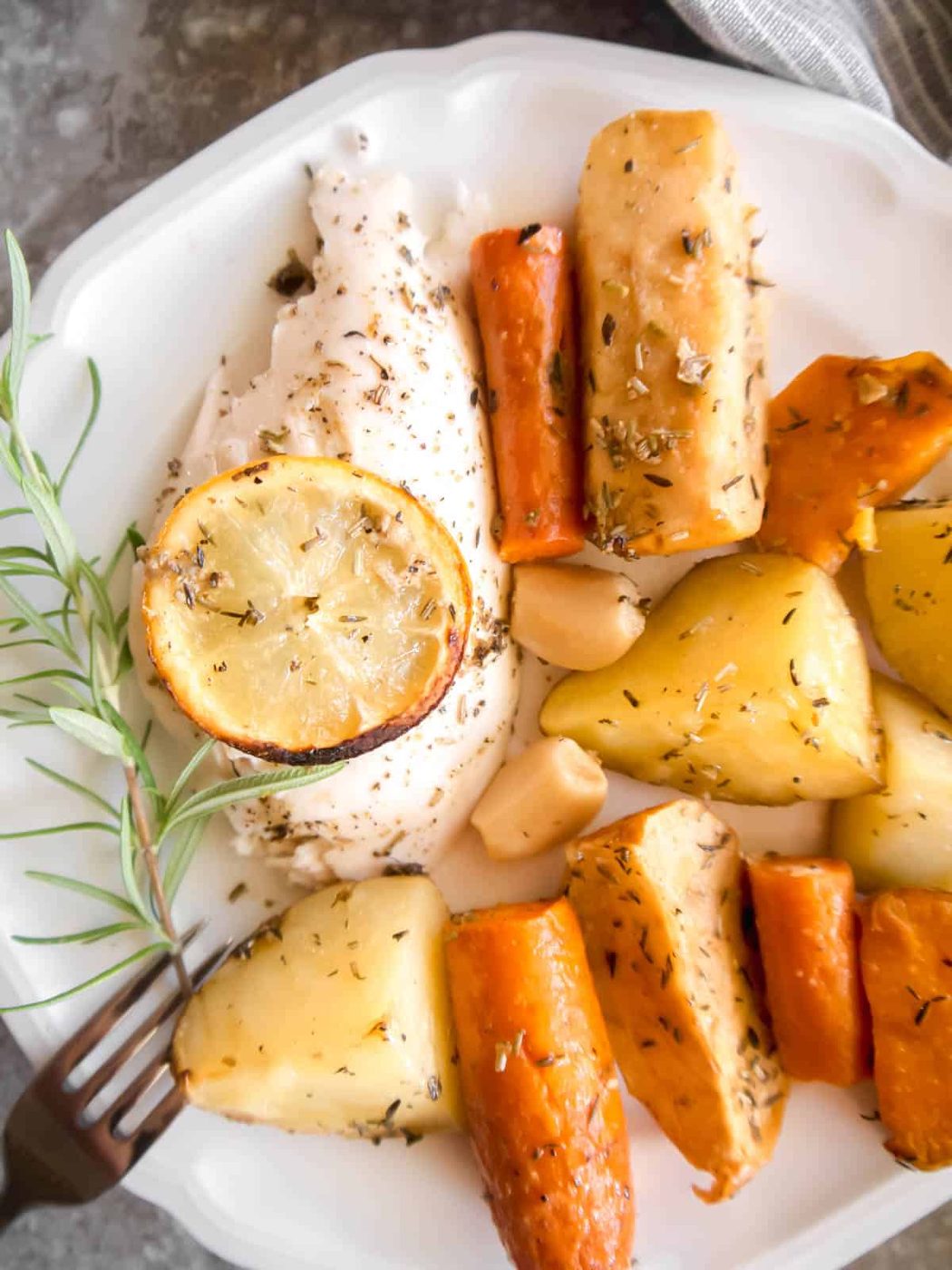 Chicken and apple recipe on a plate with veggies.