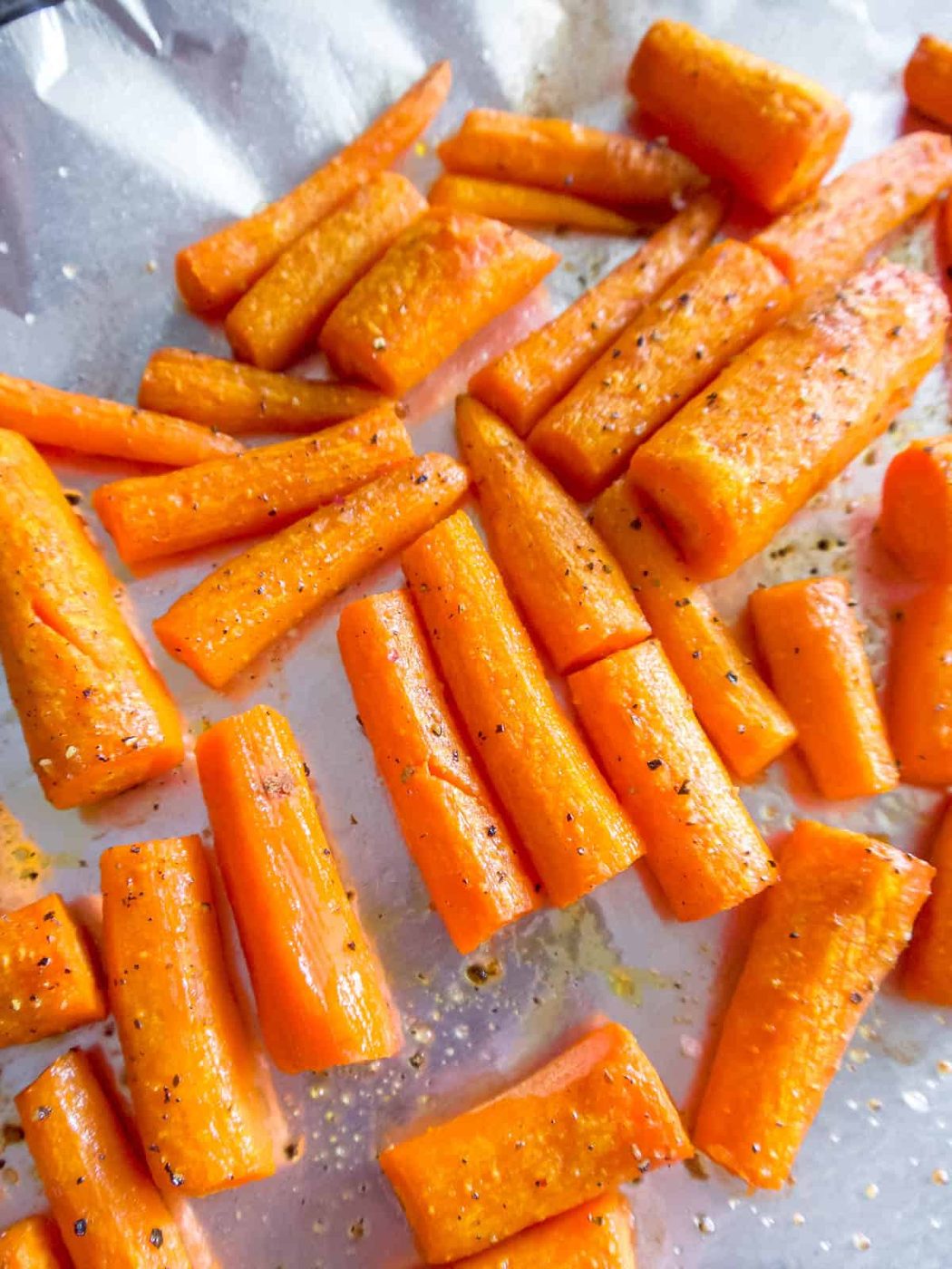 Peeled carrots cut into 2 inch pieces to be roasted.