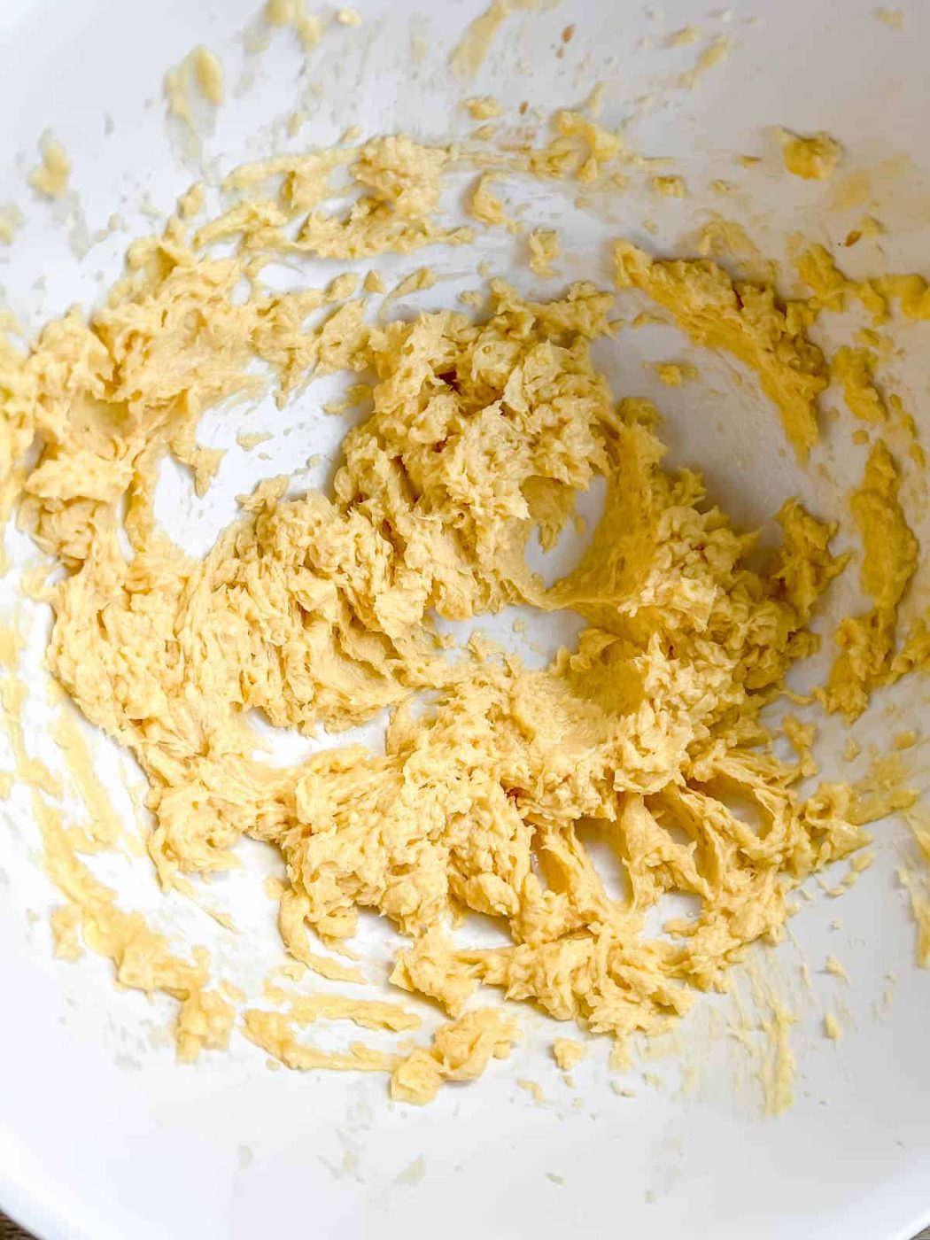 Butter and sugar creamed together in a bowl.