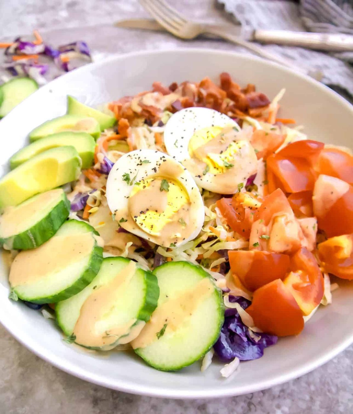 A cabbage cobb salad in a bowl.