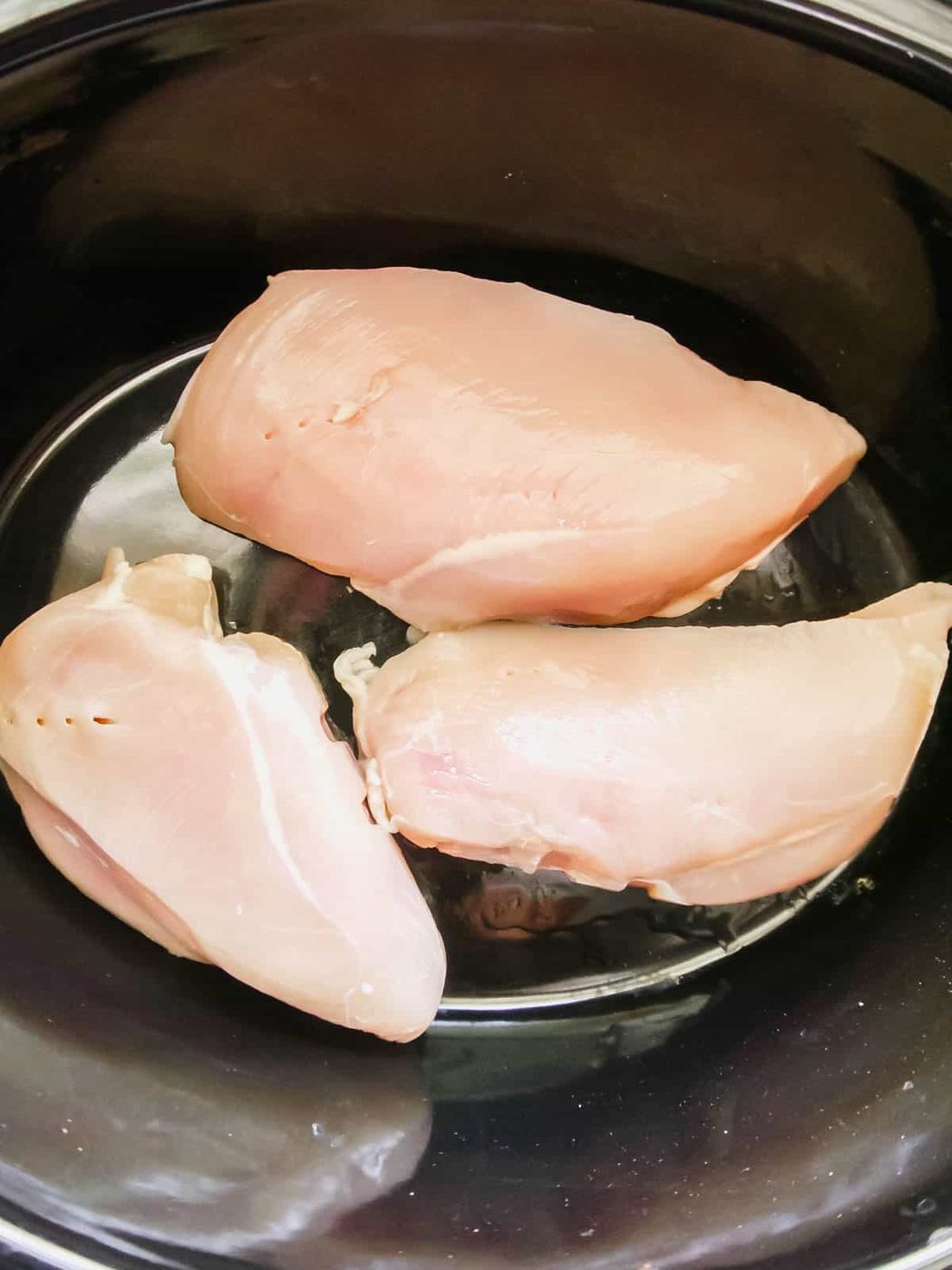 Raw chicken in slow cooker.