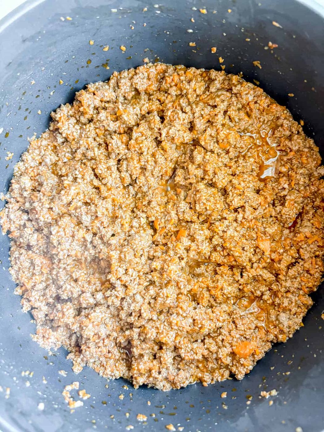Browned ground beef in a pan.