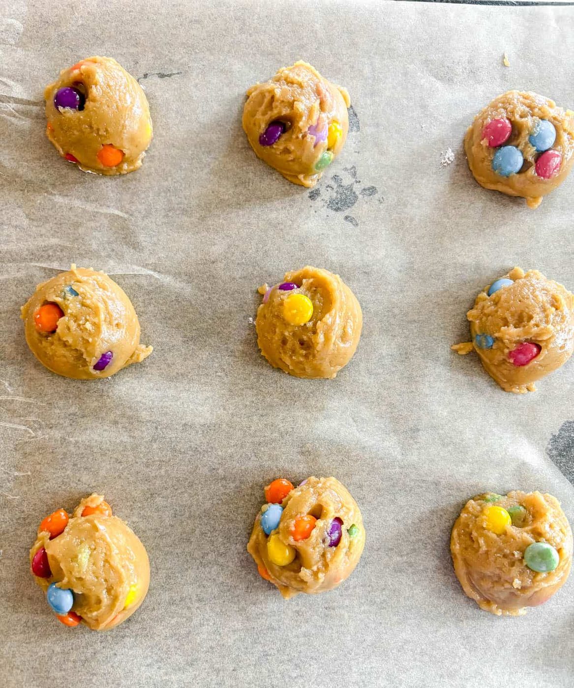 Chocolate chip cookies on a pan before baking.