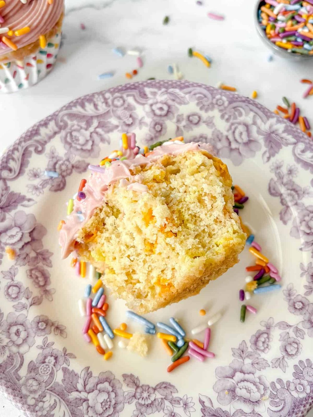 A from-scratch funfetti cupcake bitten into.