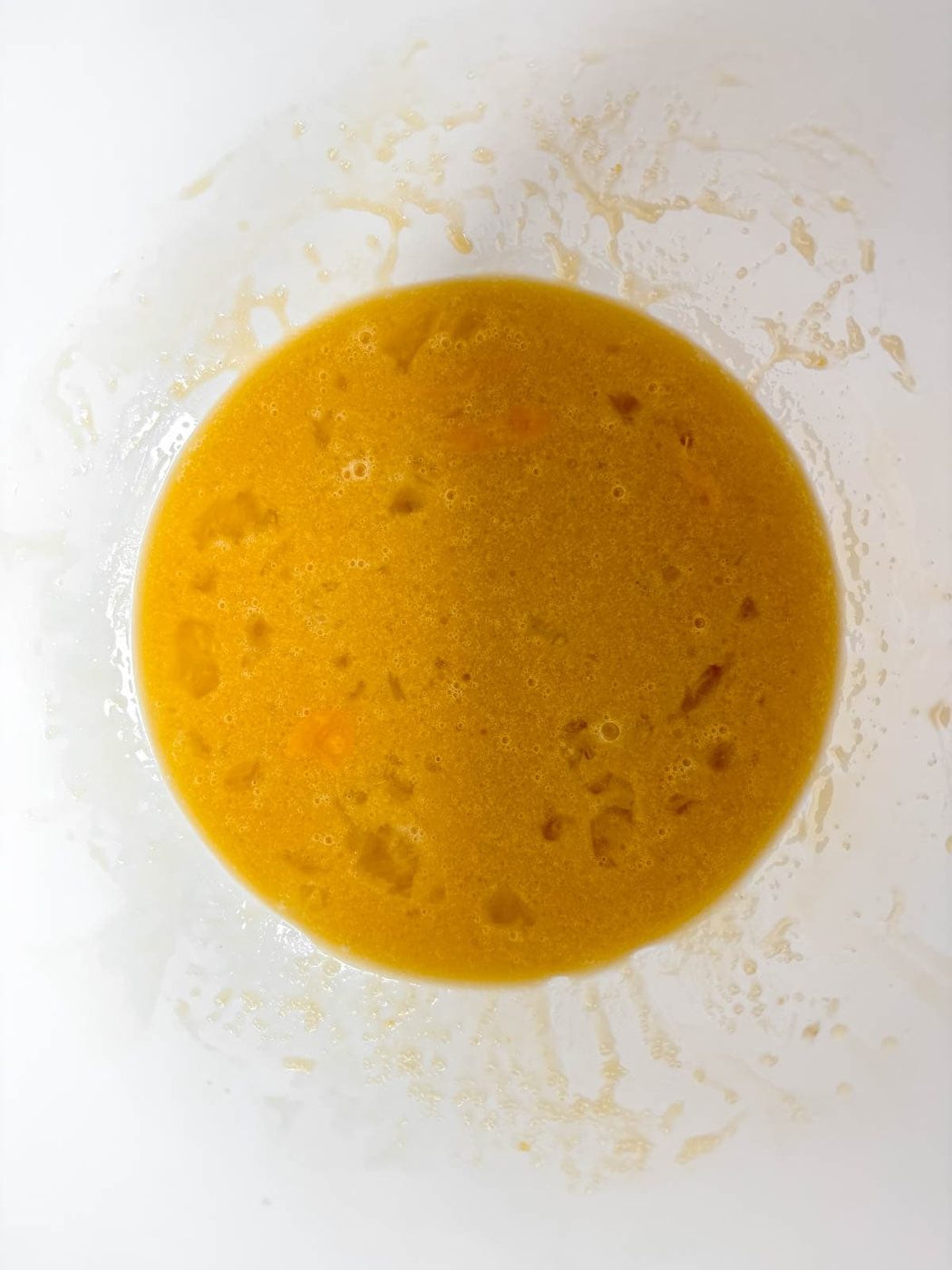 Wet ingredients needed to make funfetti cupcakes in a bowl.