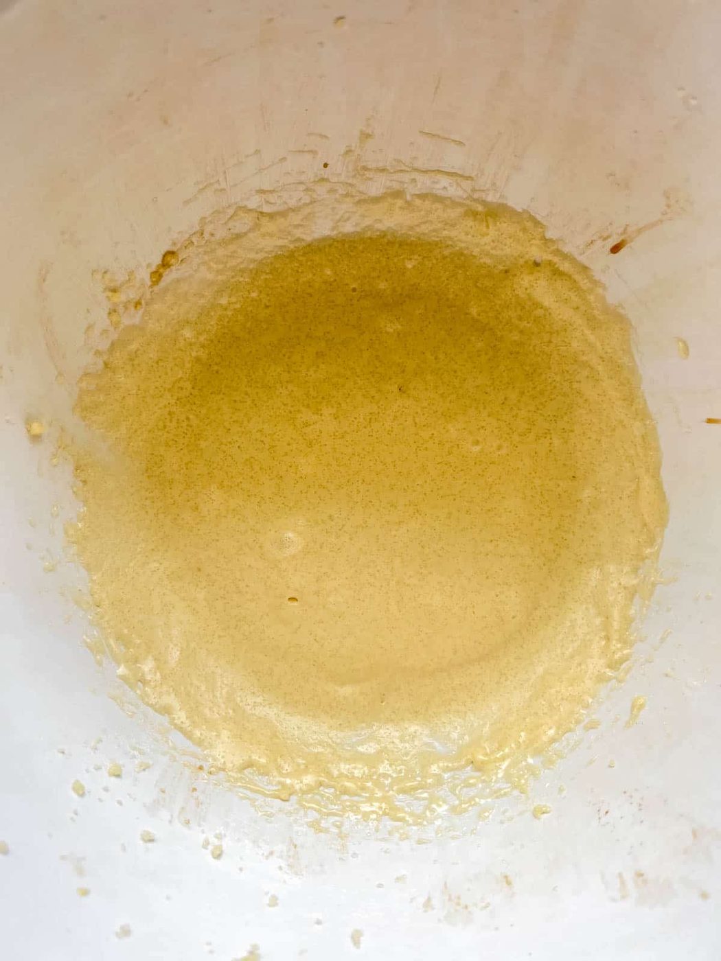 Eggs and sugar whisked in a bowl.