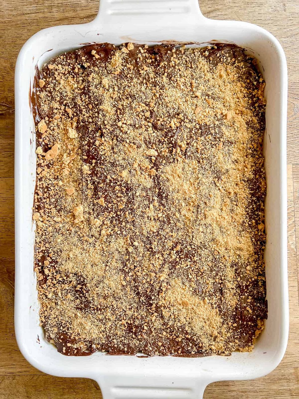 Crushed graham crackers added to melted chocolate.