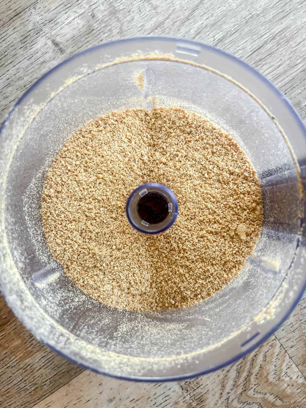 Crushed graham crackers in a food processor.