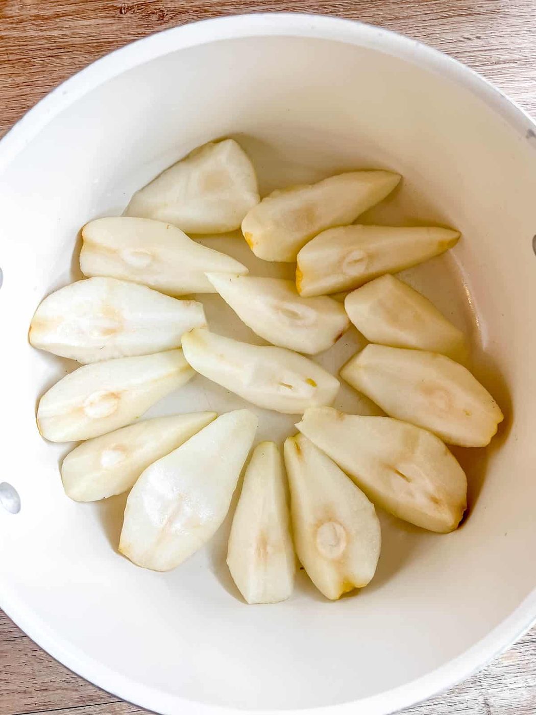 Pears in a large soup pan.