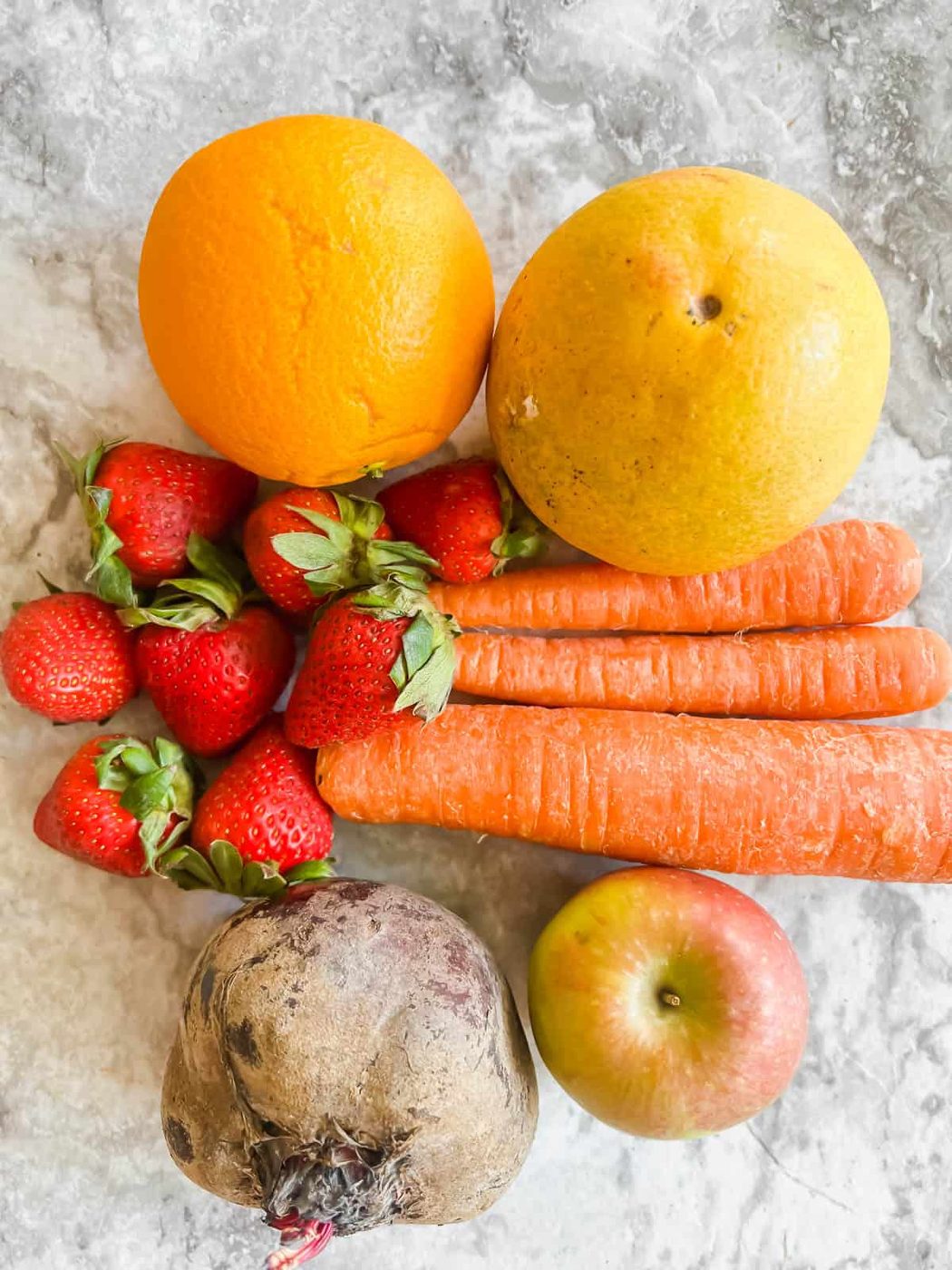 Ingredients needed to make Strawberry Apple Beet Carrot Juice.