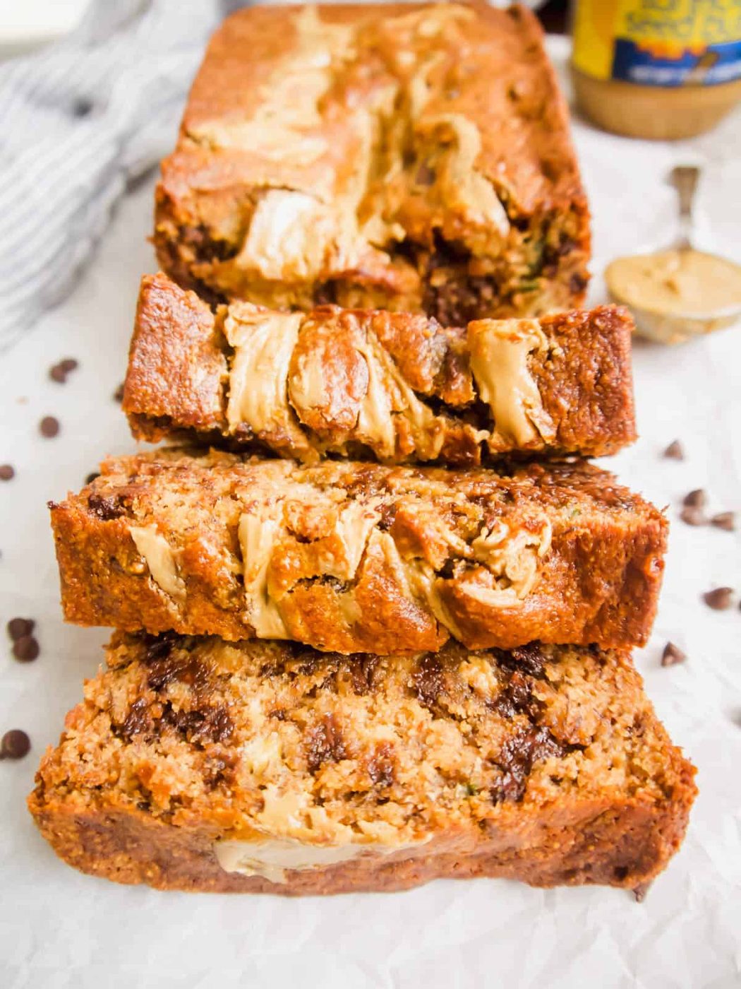 Sliced banana bread with sunflower butter and chocolate chips.