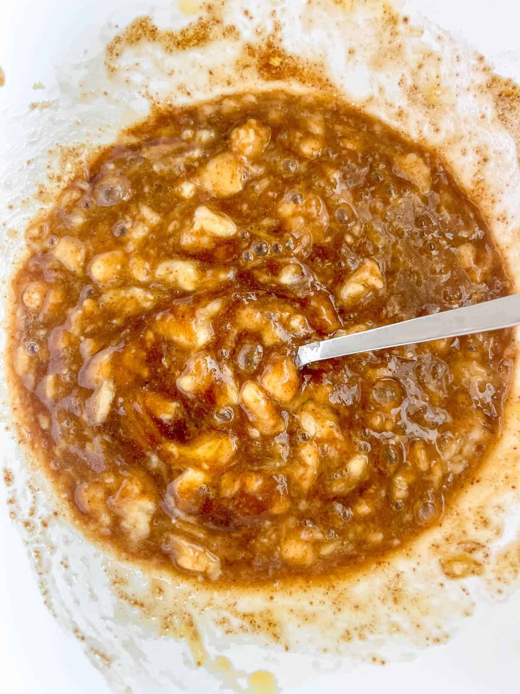 Mashed bananas added to a bowl.