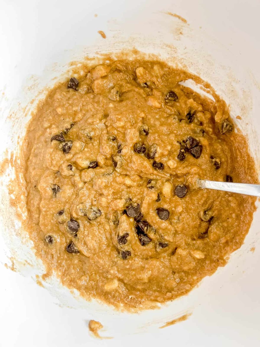 Wet ingredients to make banana bread with sunflower butter and chocolate chips.