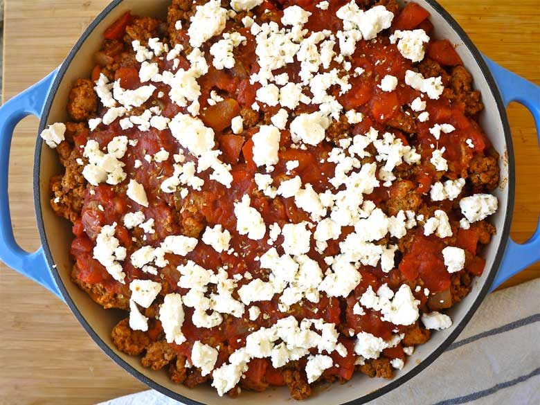Layered enchilada casserole before baking.