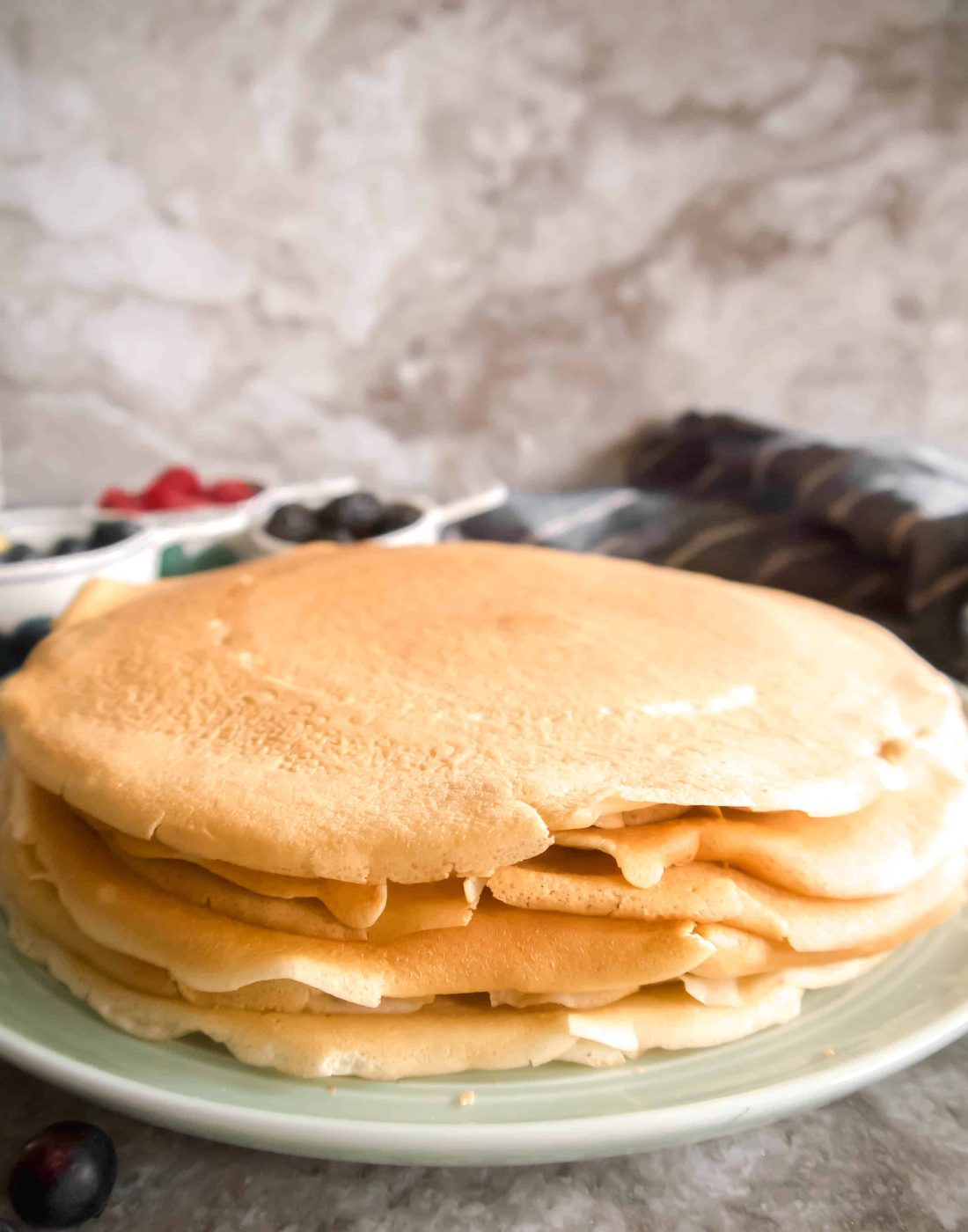 A stack of dairy free crepes on a plate.