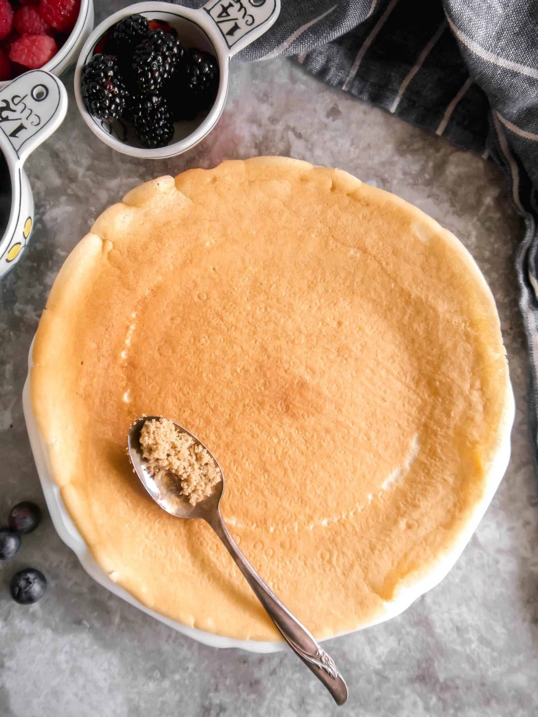 A spoon with brown sugar on a crepe.