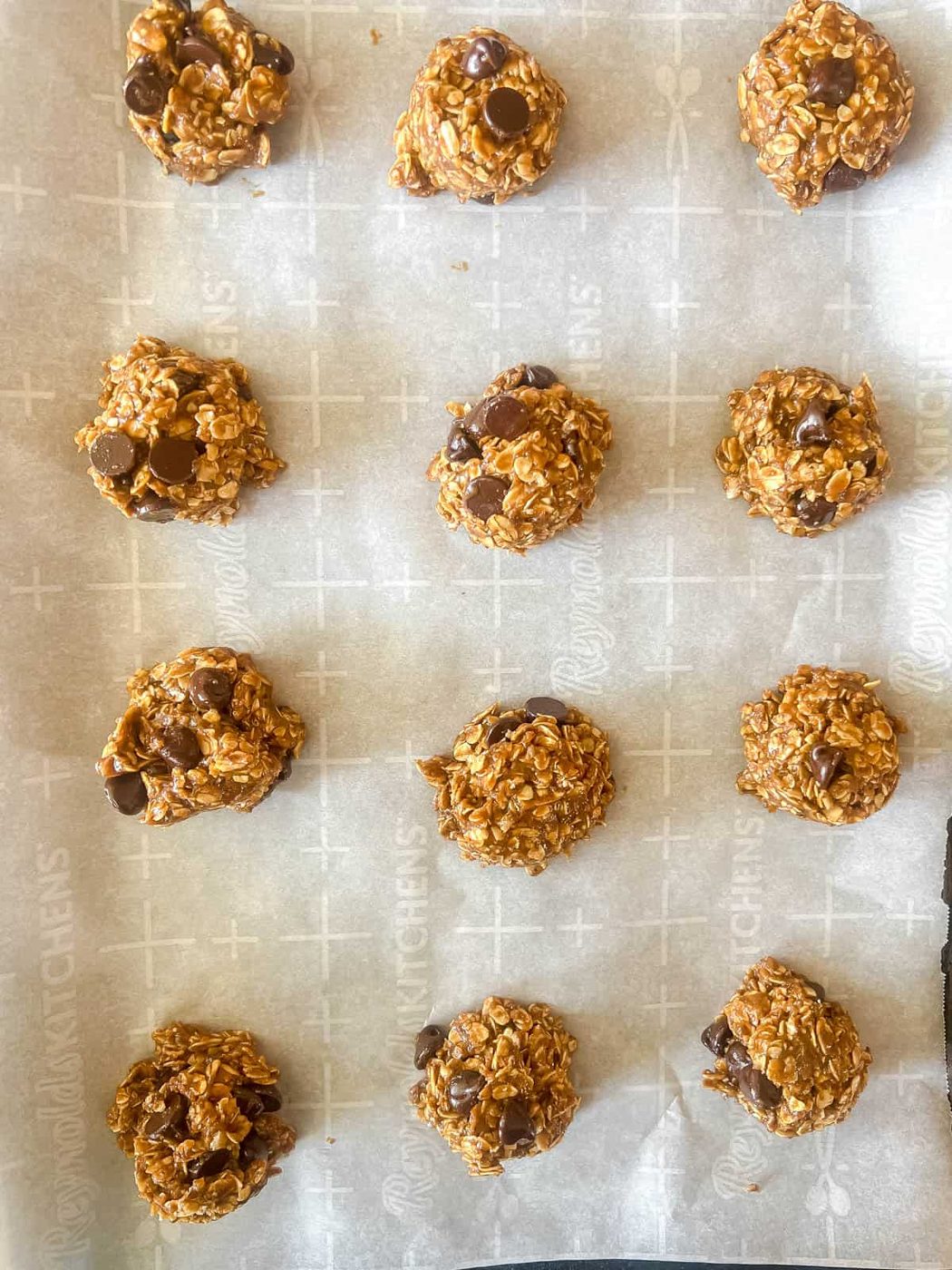 Cookie dough scooped onto pan before baking.
