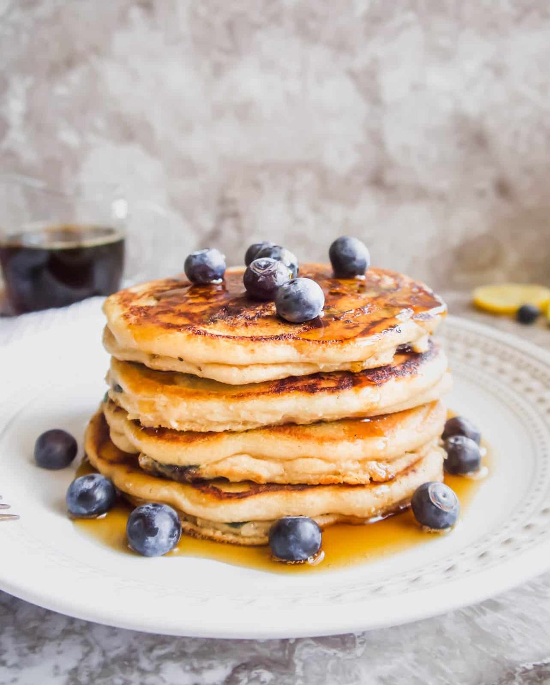 A stack of almond flour blueberry pancakes on a plate.