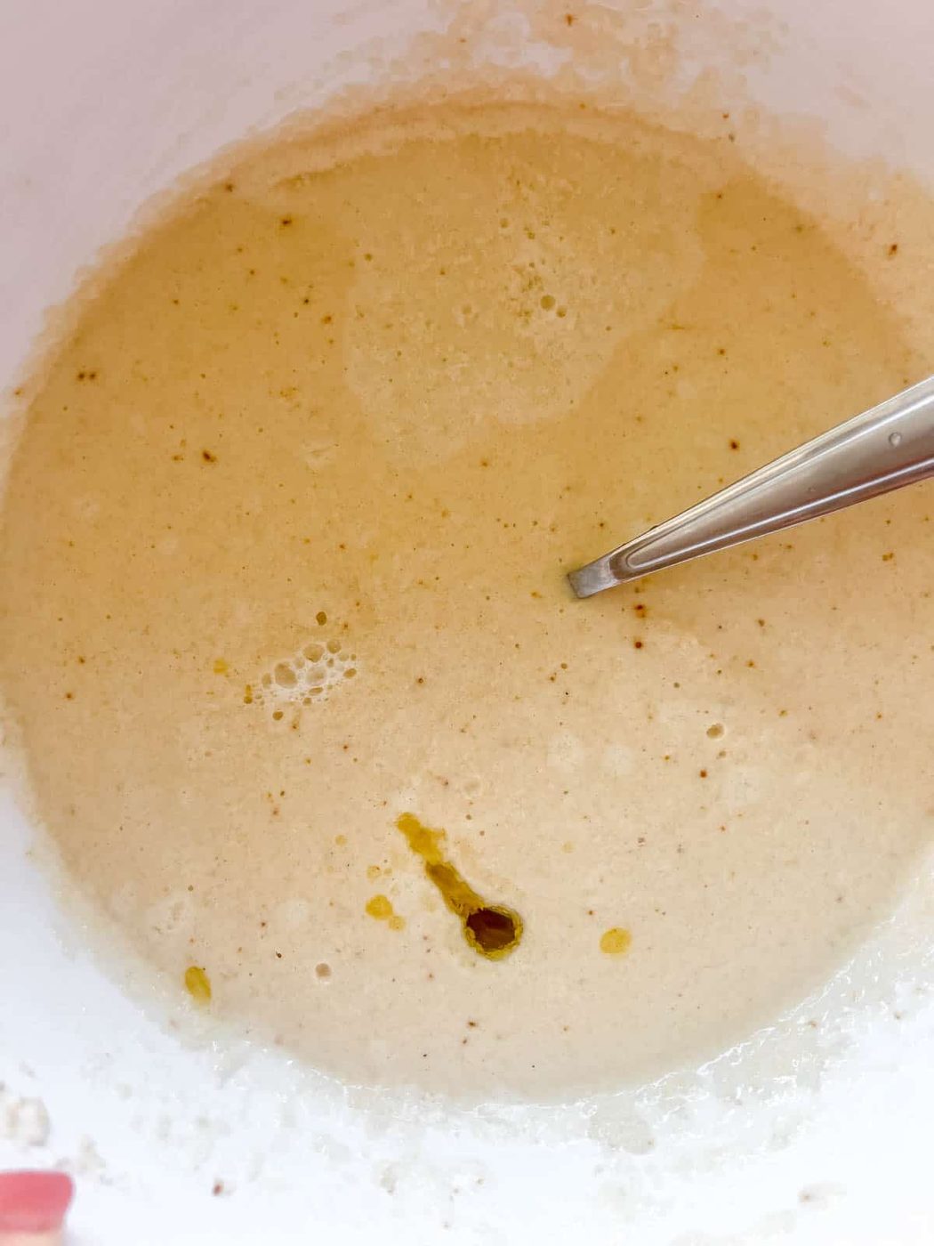 The wet and dry ingredients mixed together for paleo pancakes.