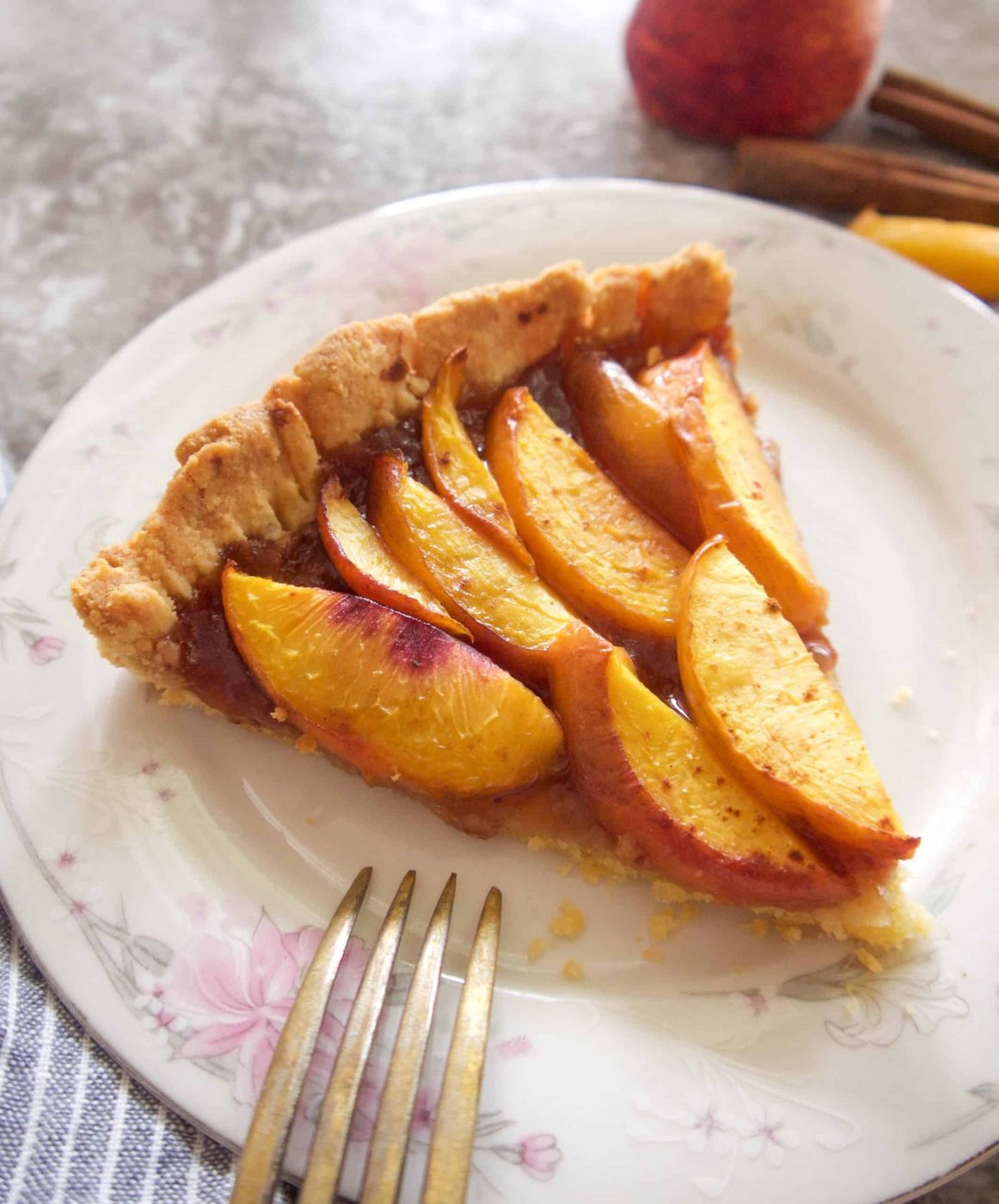 A slice of gluten free nectarine tart on a plate.
