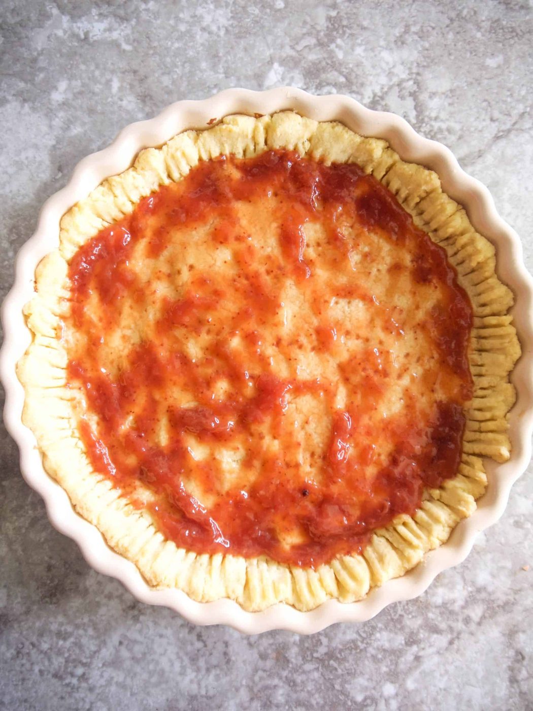 A layer of jam added to tart crust.