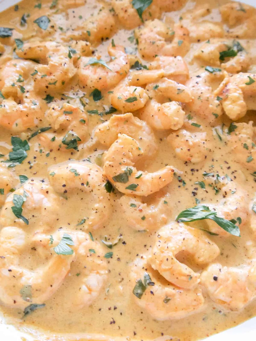 Coconut cream, lemon juice, shrimp, parsley, and paprika added to the pan.