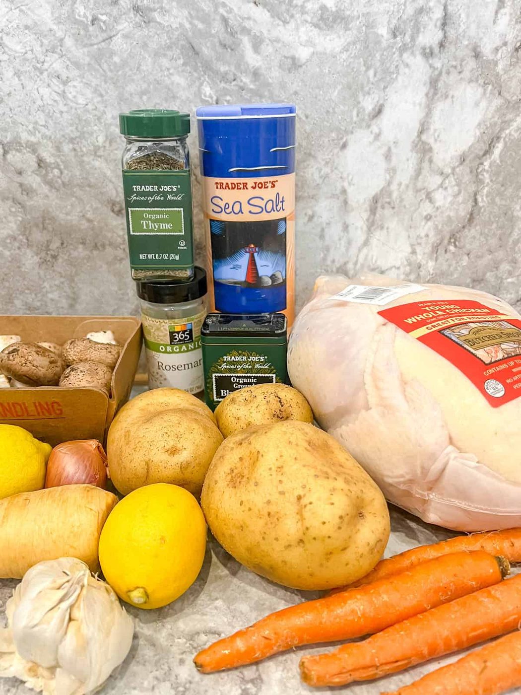 Ingredients needed to make lemon thyme roasted chicken with root vegetables.