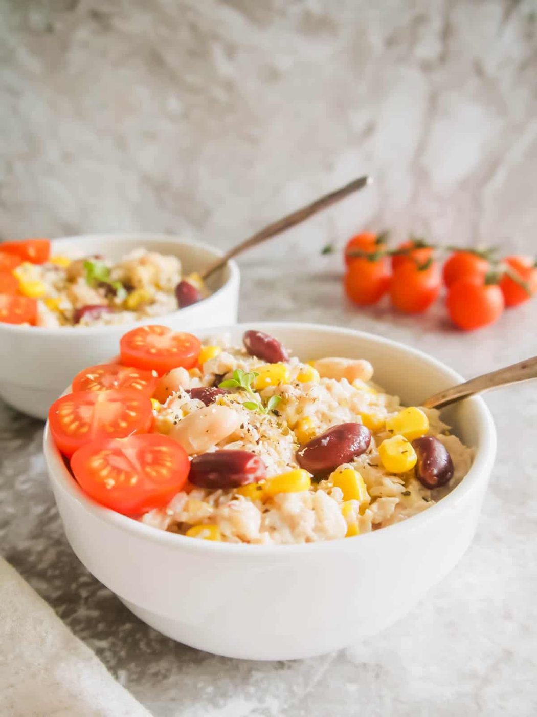 Tuna with rice salad in a bowl with beans, corn and tomatoes.