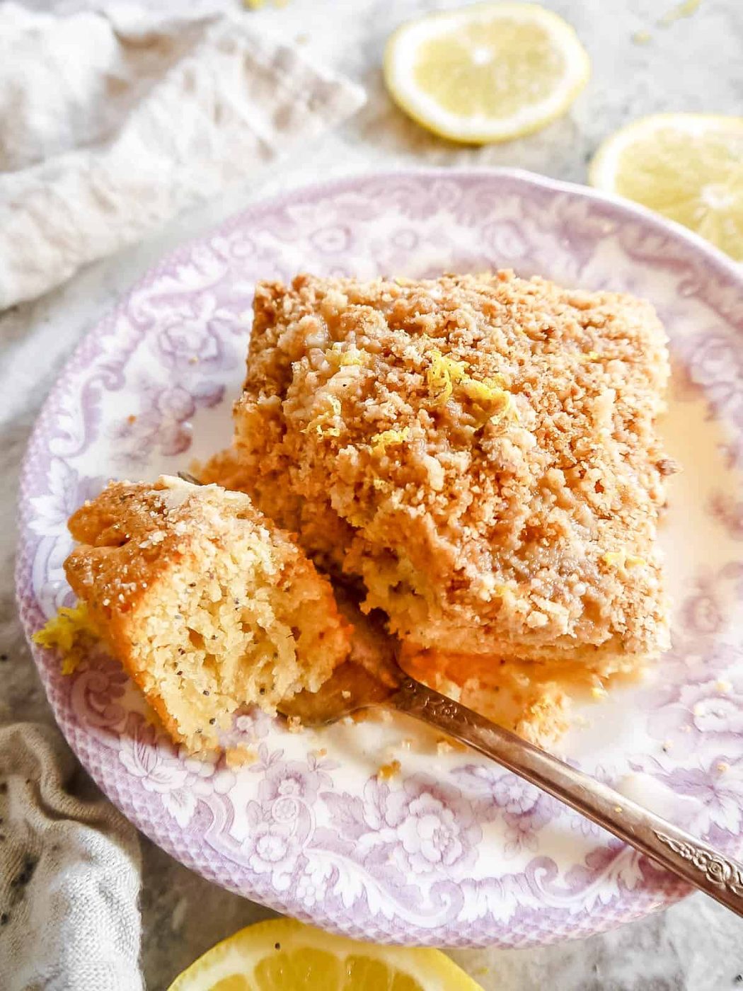 A fork digging into a Lemon crumb coffee cake.