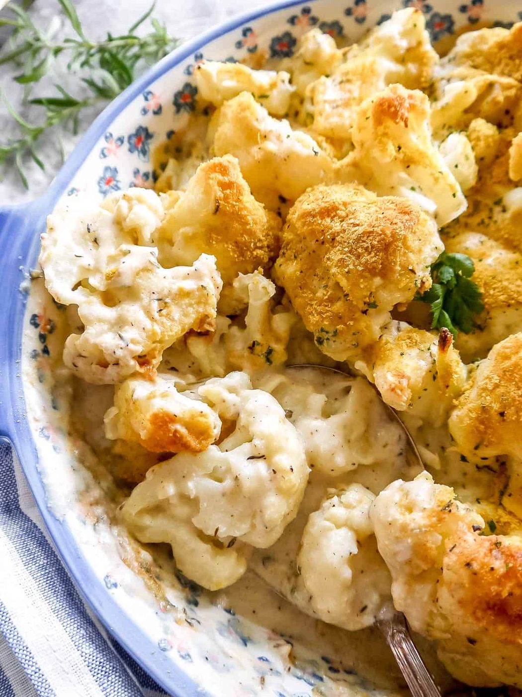 Dairy-free cauliflower bake with a spoon in the dish.
