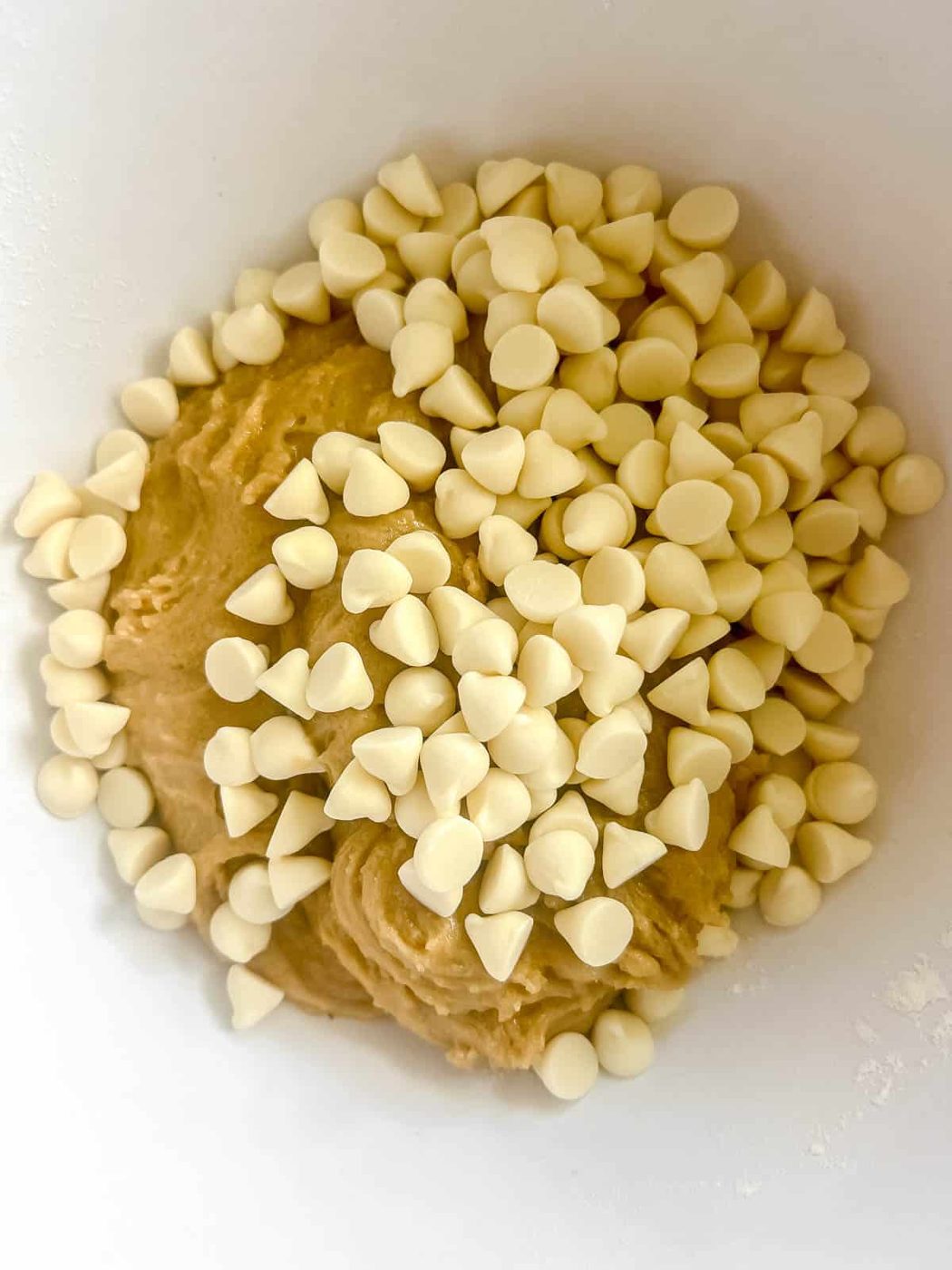 Cookie dough with white chocolate chips on top.