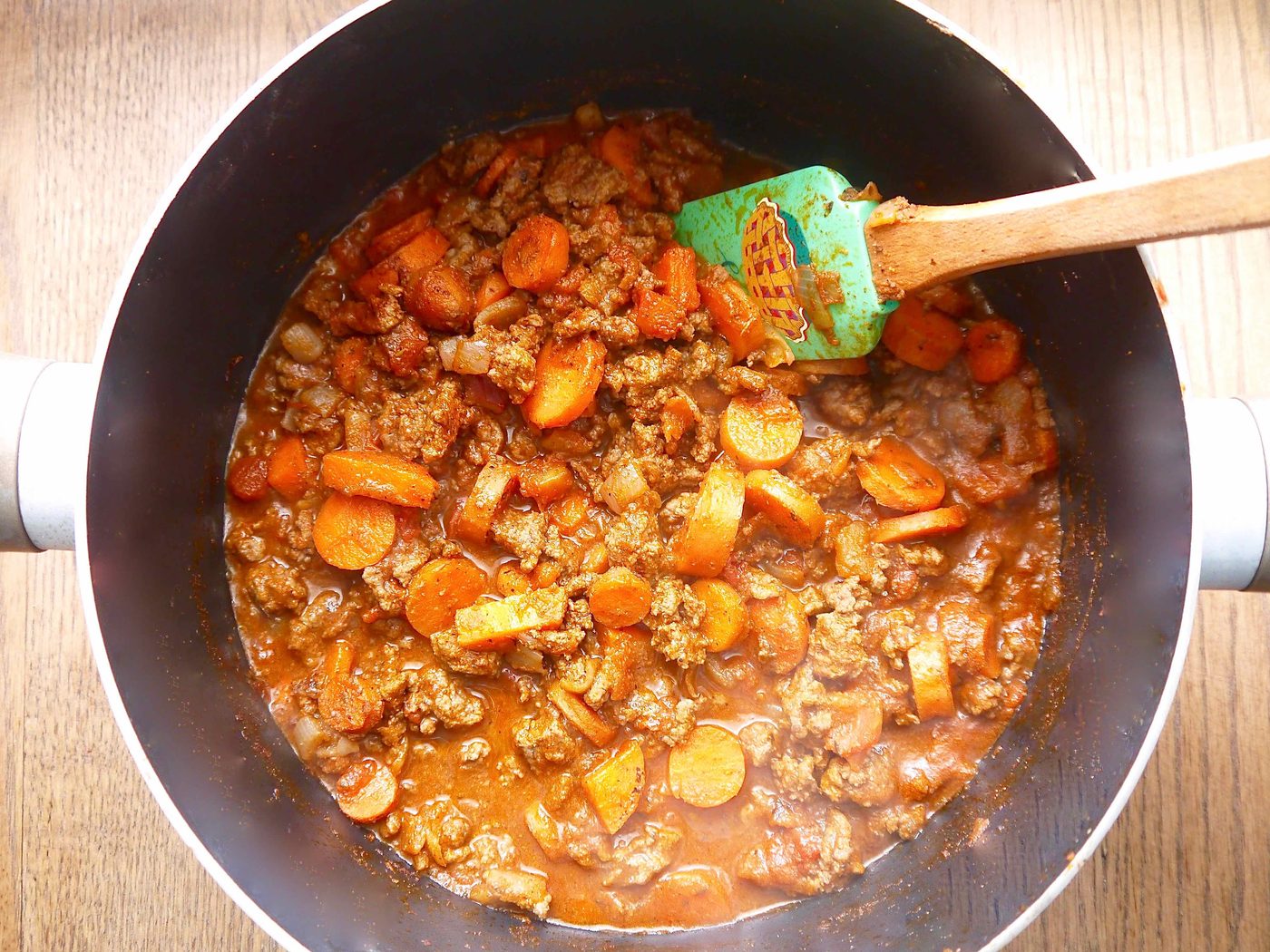 Carrot and beef gravy in a pan.