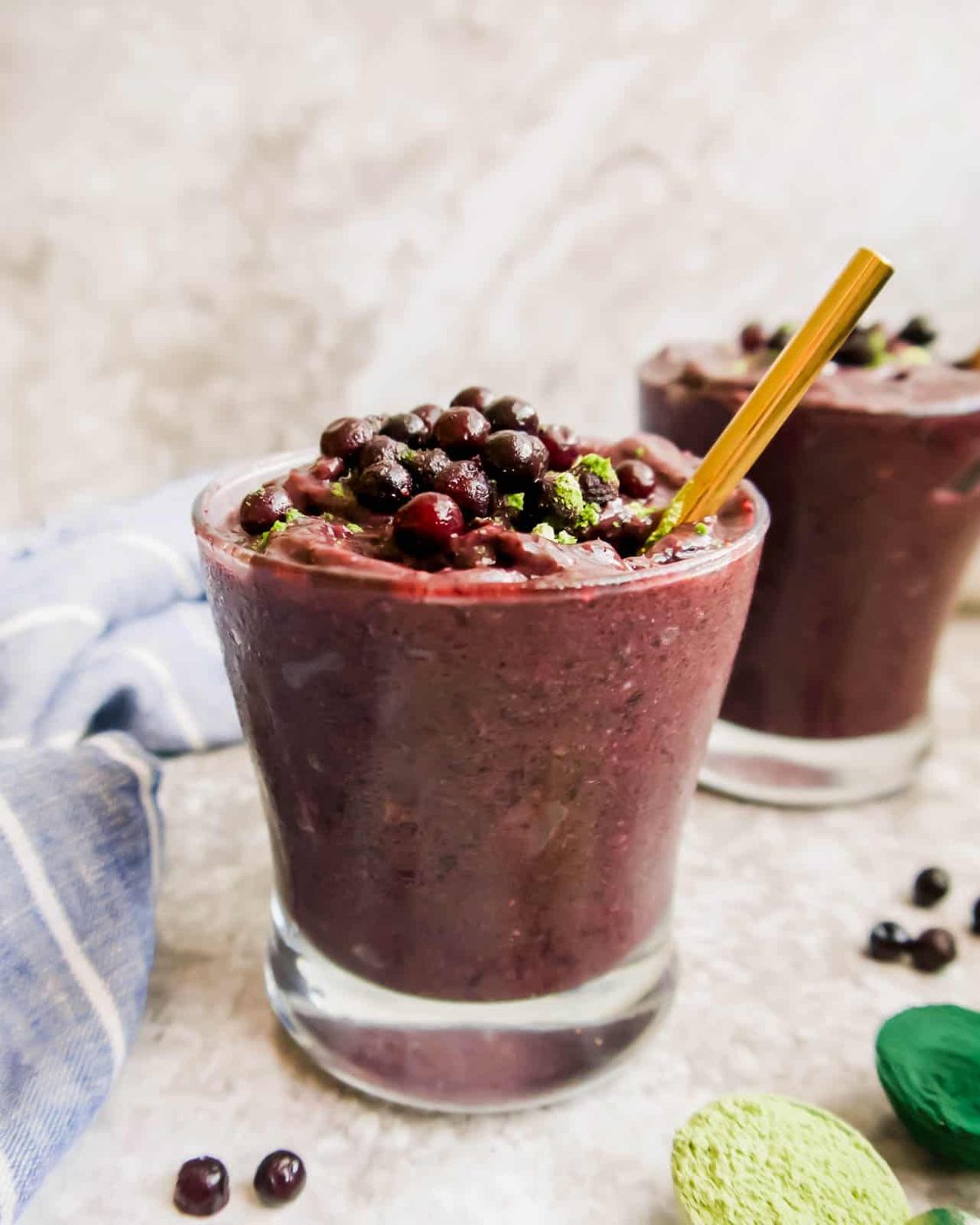 Side angle of blueberry orange smoothie in a glass.