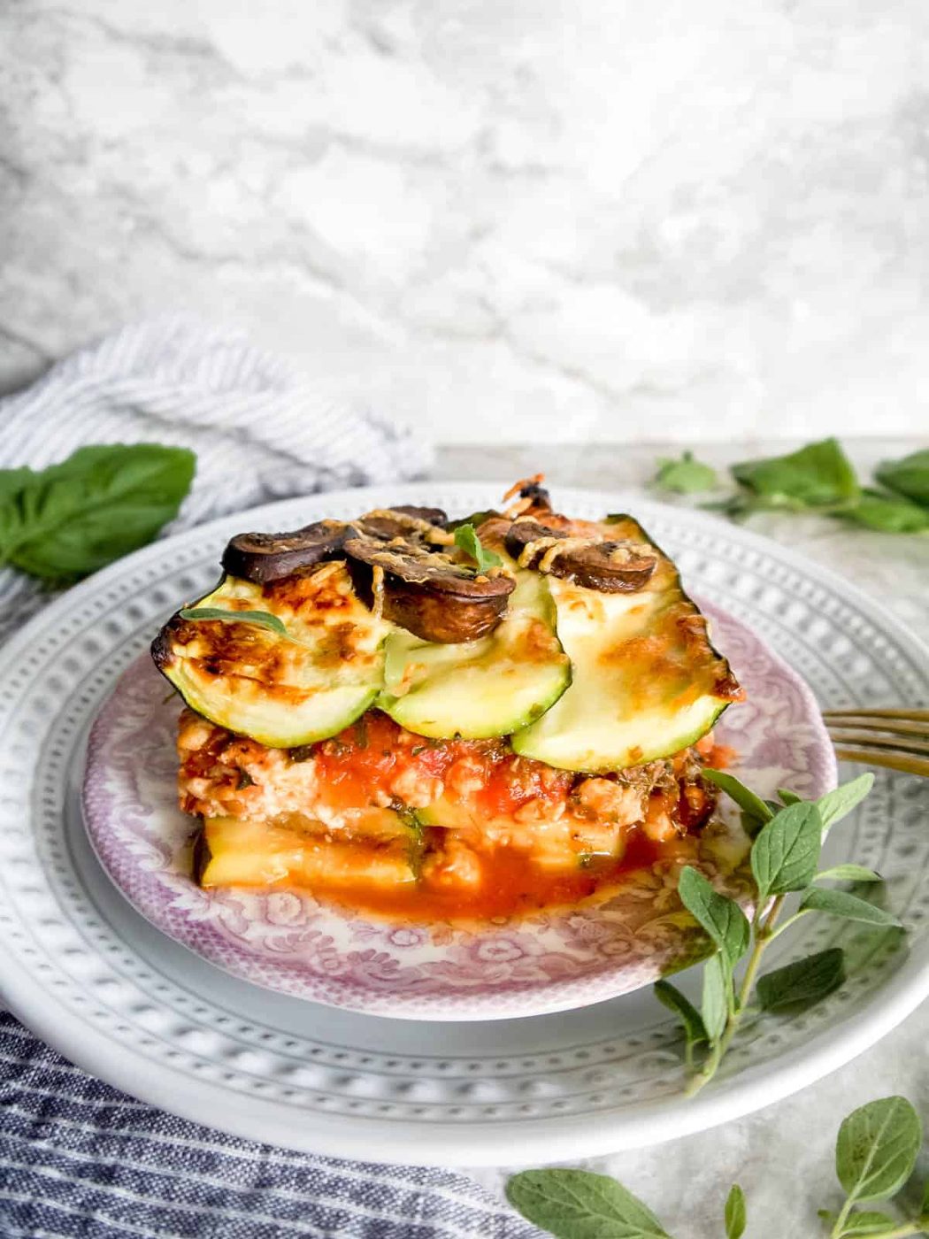 A slice of Mushroom zucchini lasagna on a plate.